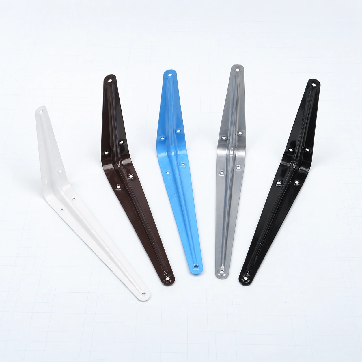 Five triangular metal shelf brackets in multiple finishes on a pale ice-blue studio background